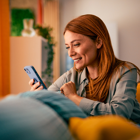 woman-using-phone-sofa-1-1-544x544px